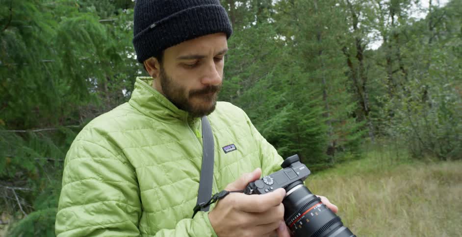 A man takes pictures in a forest