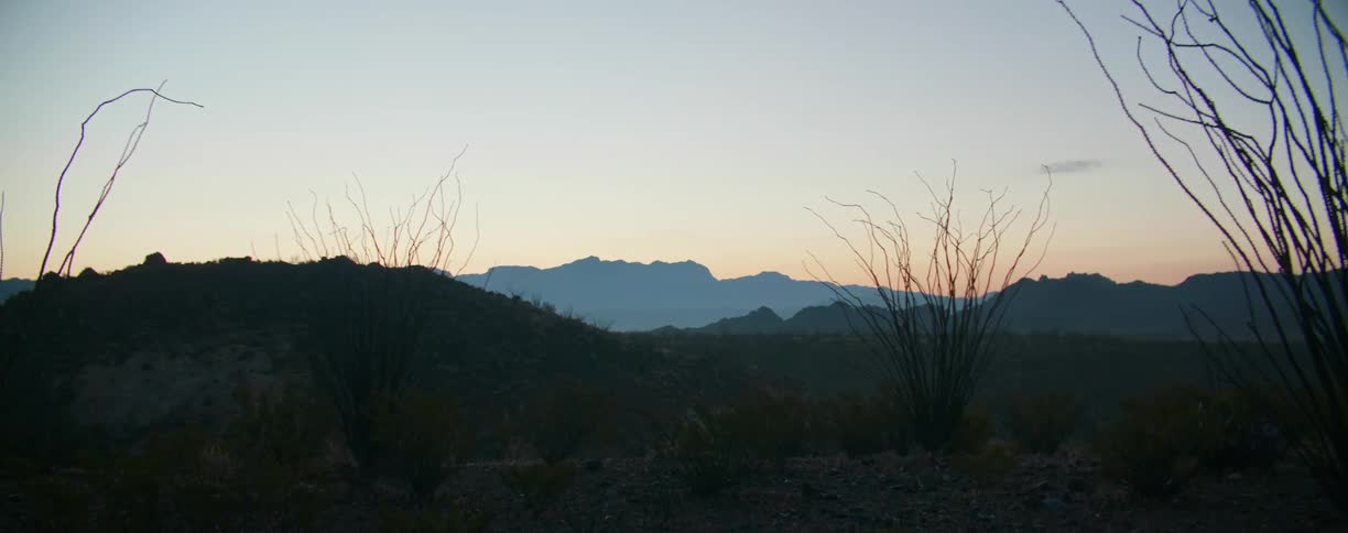 A sparse countryside populated with low mountains