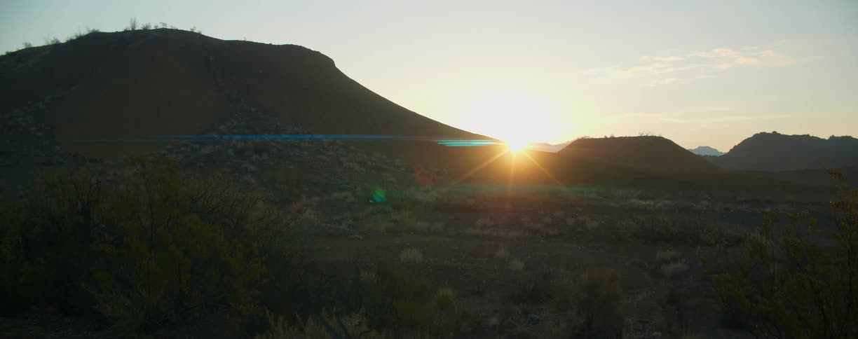 A view of a landscape is displayed at sunset