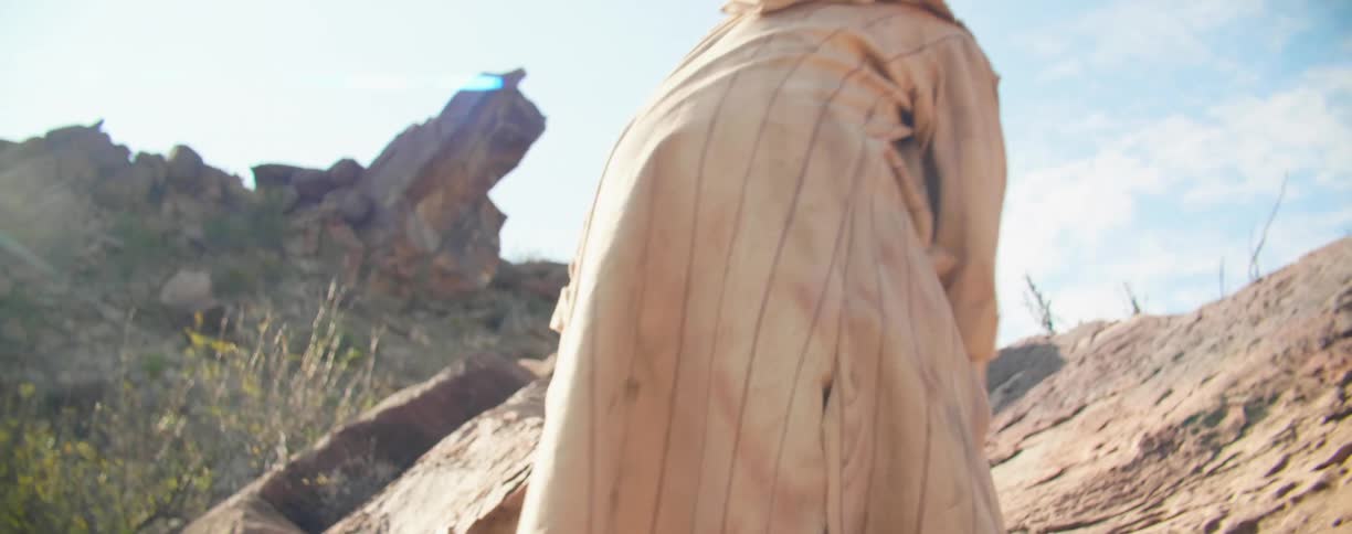 A man is climbing over the rocks