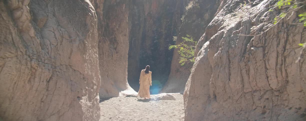 A person walks past the mountains