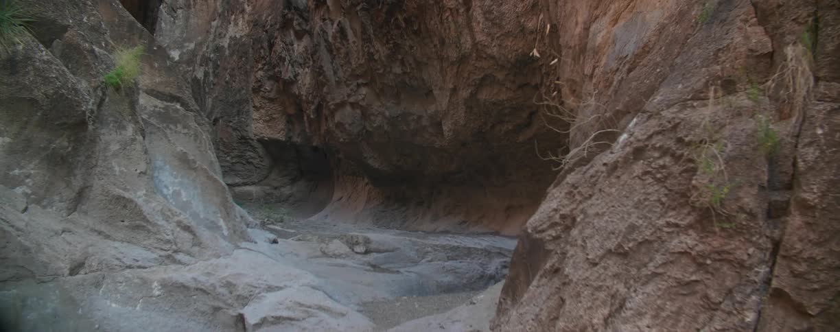 A foot path leads to a cave in a canyon