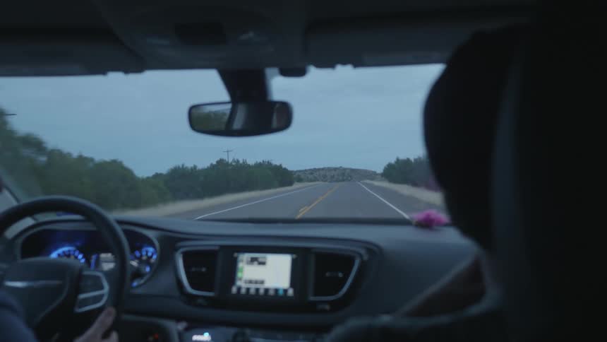 Two people are driving in a car