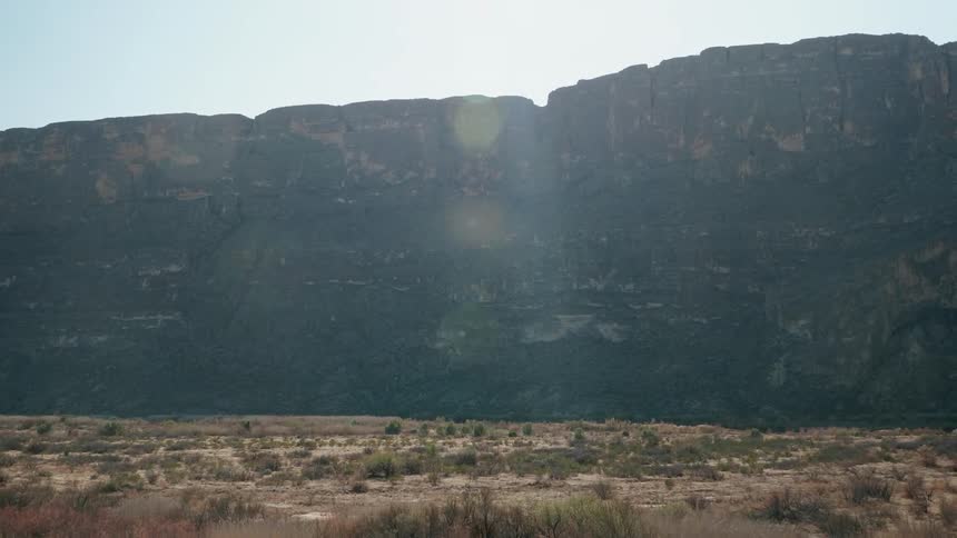 Sunlight over a mountain range on the desert