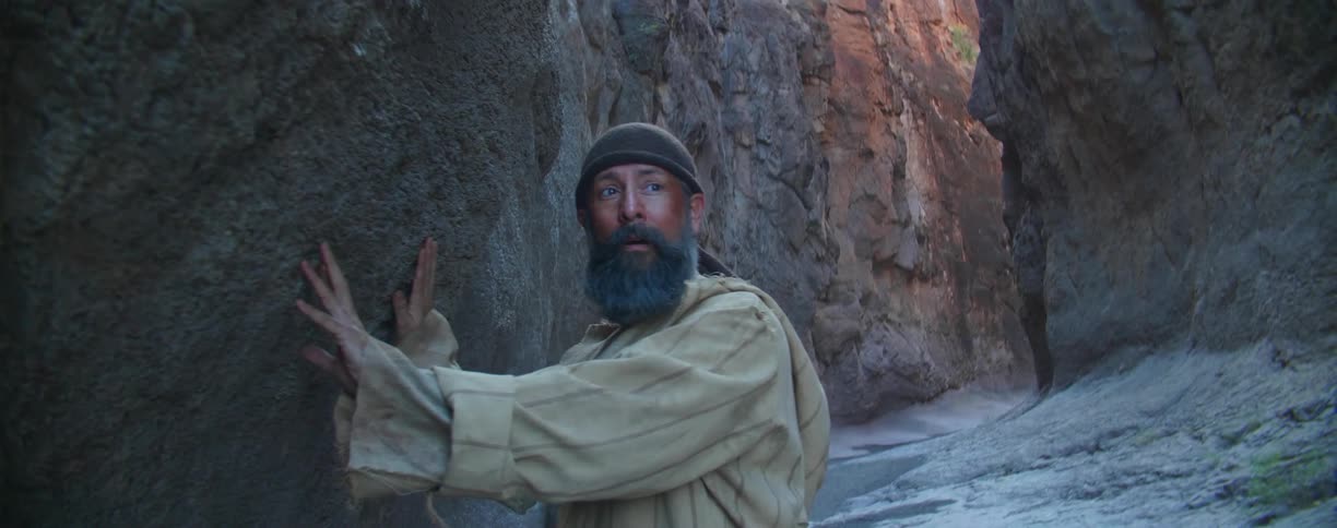 A man is standing outdoors in a third world country