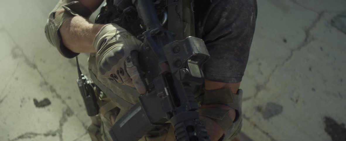 A man slowly raises his gun