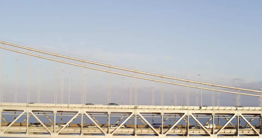 Traffic drives over a suspension bridge