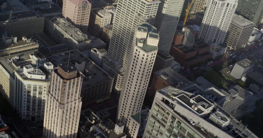 The rooftops of skyscrapers and buildings in a city on a sunny day