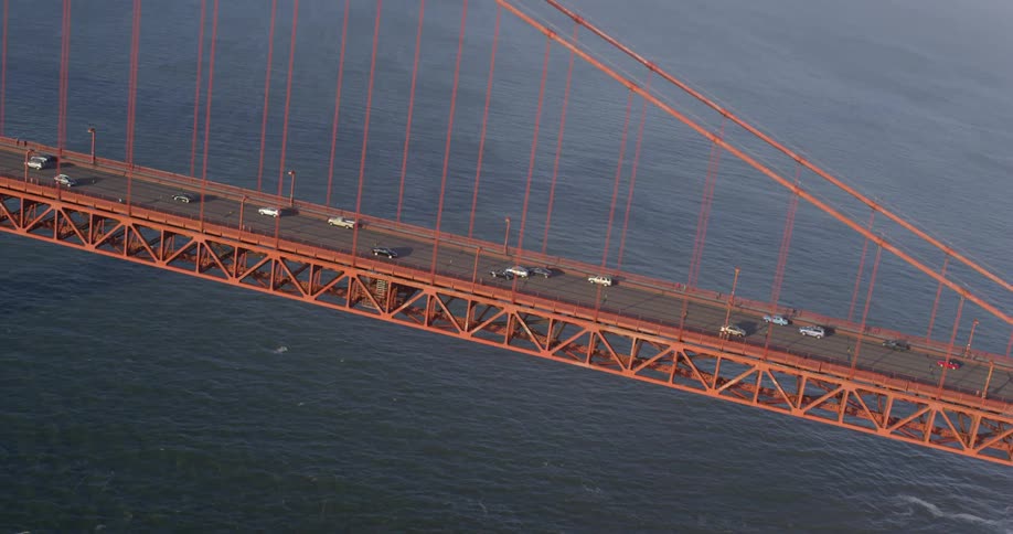 Aerial view of cars driving across a bridge