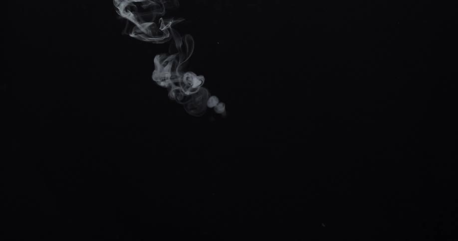 Smoke puffs rise and swirl against a black background