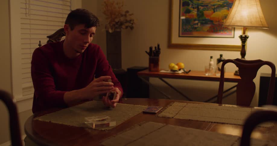 A man is playing cards in a room