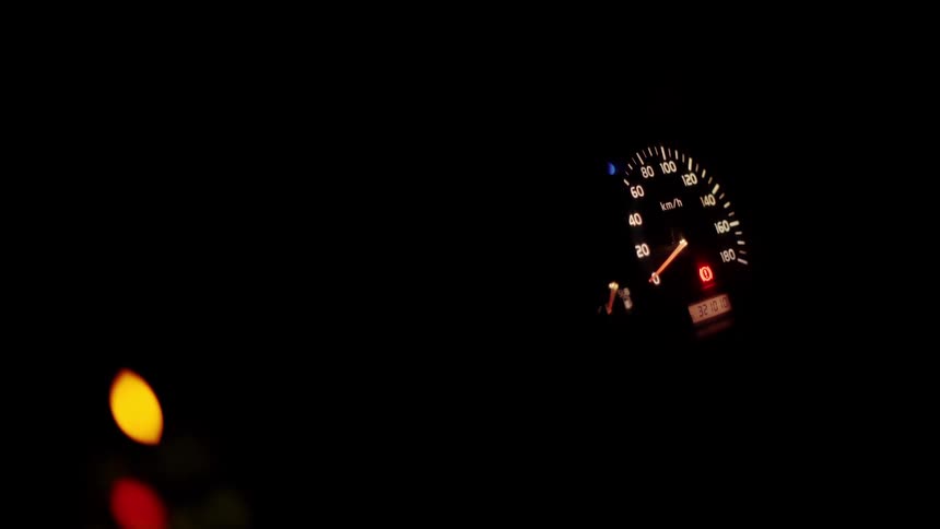 A lit up dashboard at night