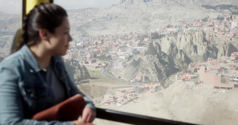 A girl looks out the window of a gondola