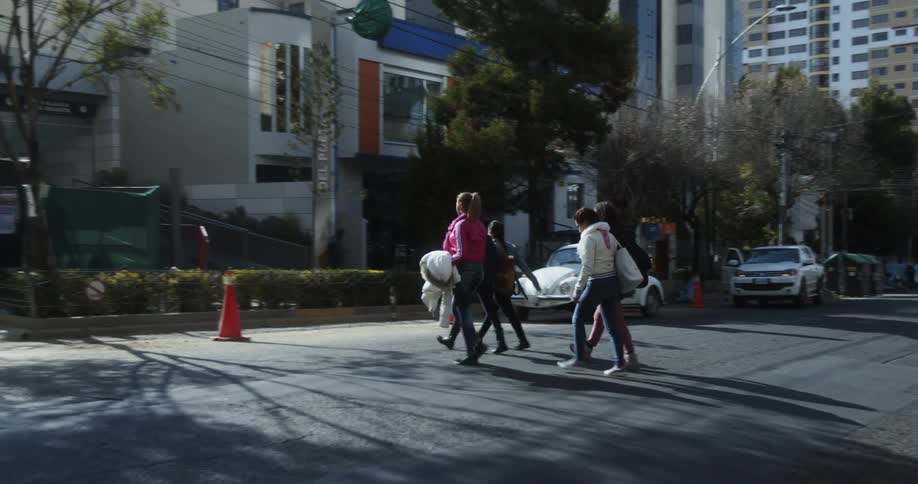 Young teenage girls cross the street on a city