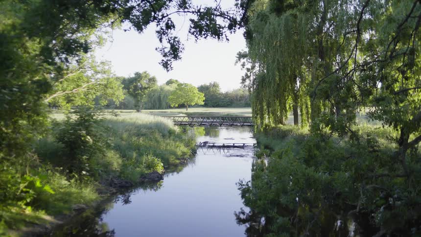 A river with bridges with trees and the sky in the background
