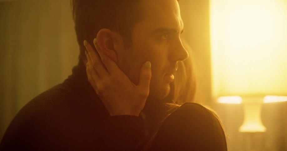 A woman and man kiss in a room