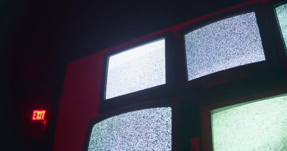 Several televisions are displaying static