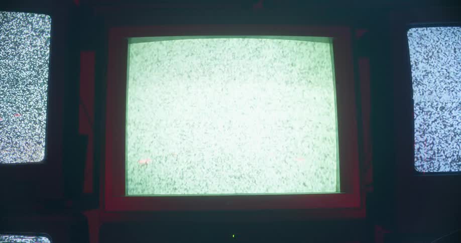 Several stacked televisions show static