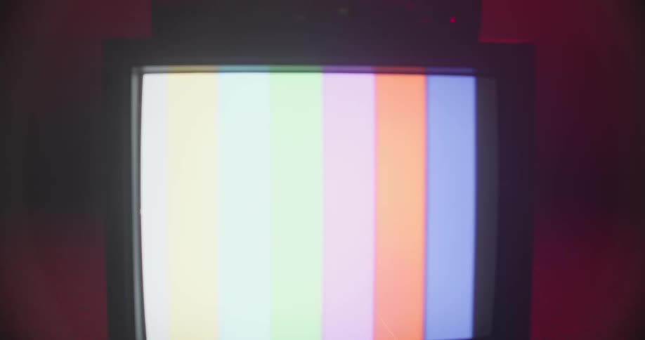 A broken television with colored lines running down the screen sits on a table inside