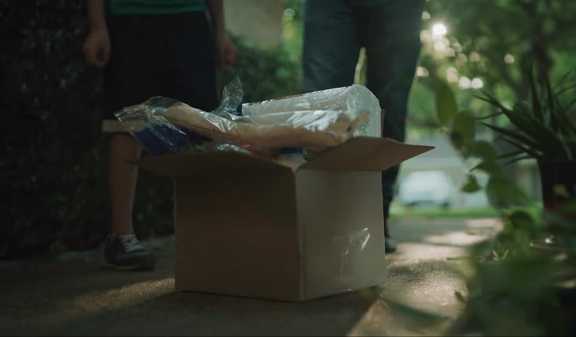A man and his child set a box outside