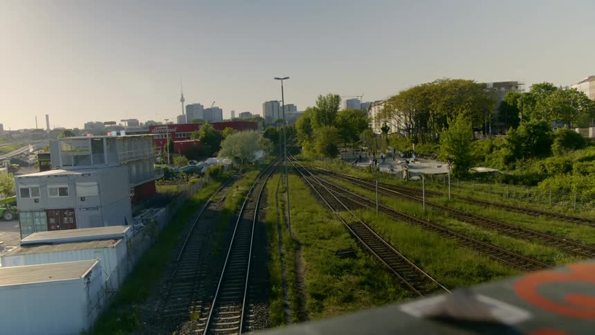 The train tracks are empty by the city