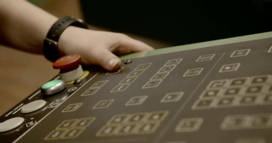 Person rests hands on control on panel