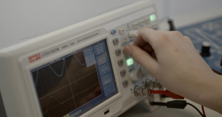 A person adjusts dials on medical equipment
