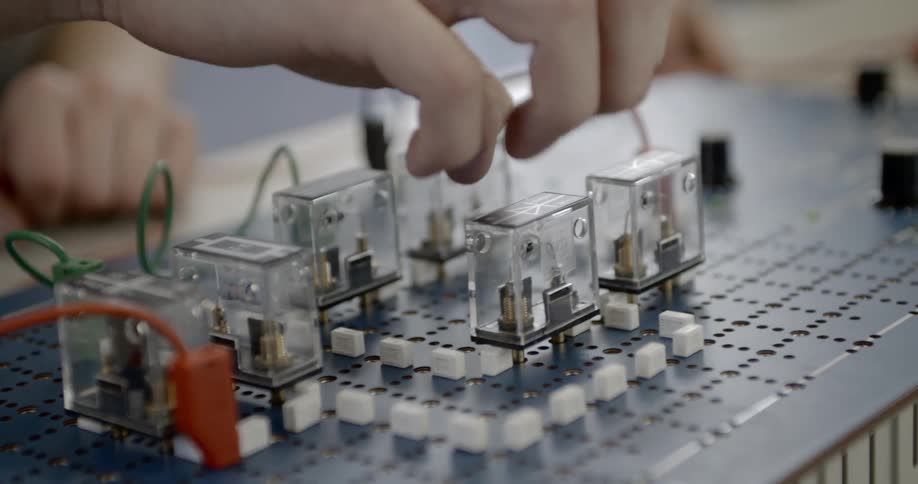 Man moves and replaces transparent electronic components on a board