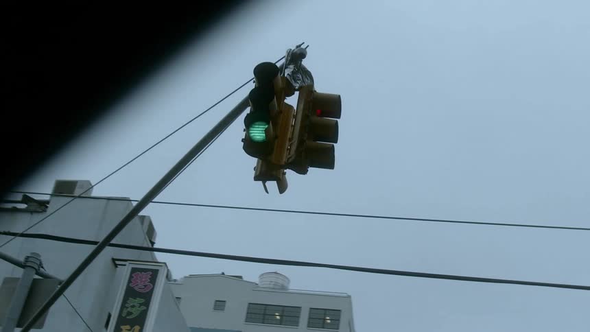 A traffic light stays green at a city intersection