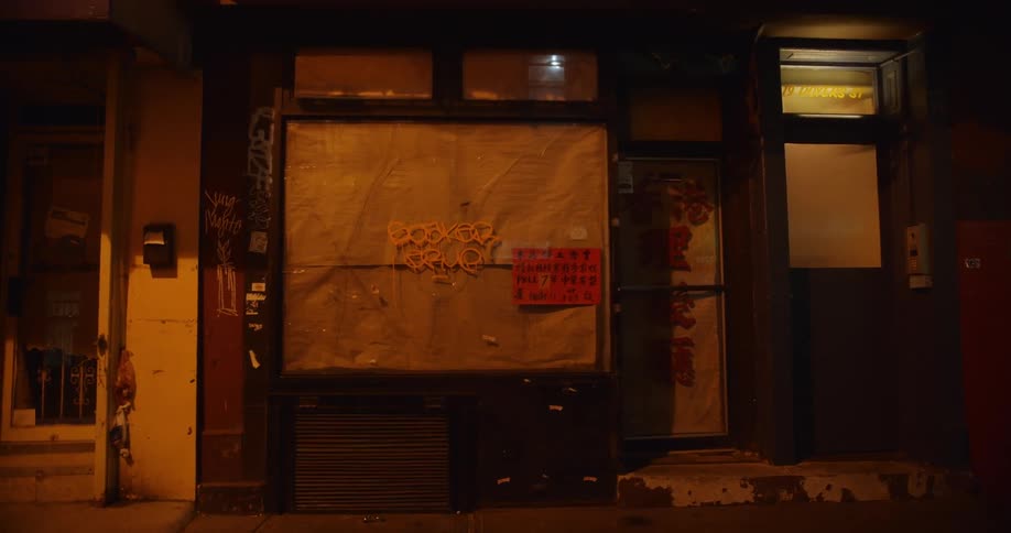 The store is closed up with graffiti on the window