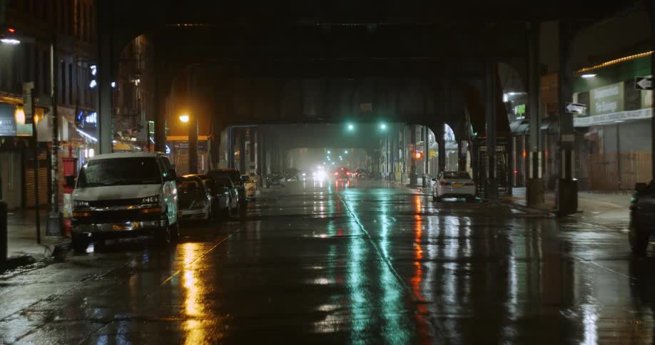 It is raining at night in the city