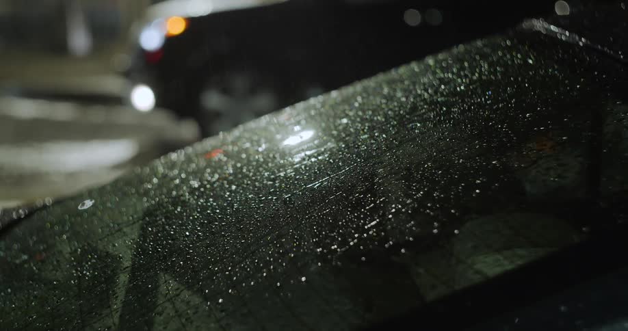 Rain falling on parked cars