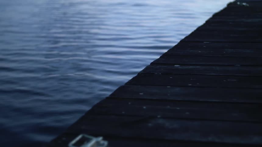 A dock with the water moving beneath it