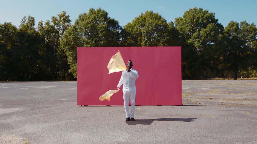 A man is dancing and waving flags