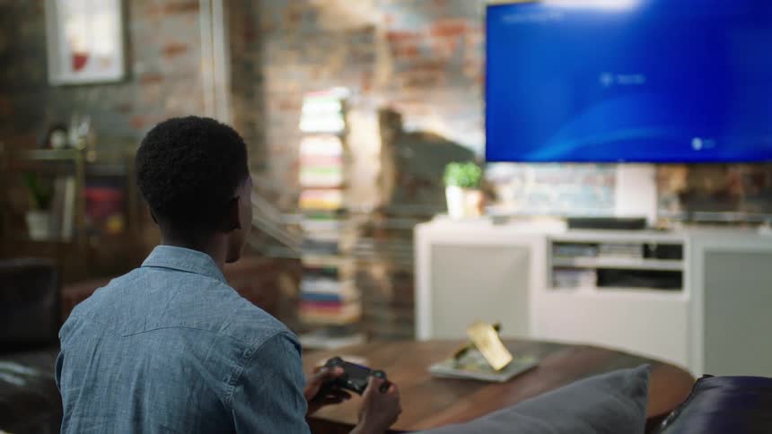 Person uses video game controller to scroll through information on screen