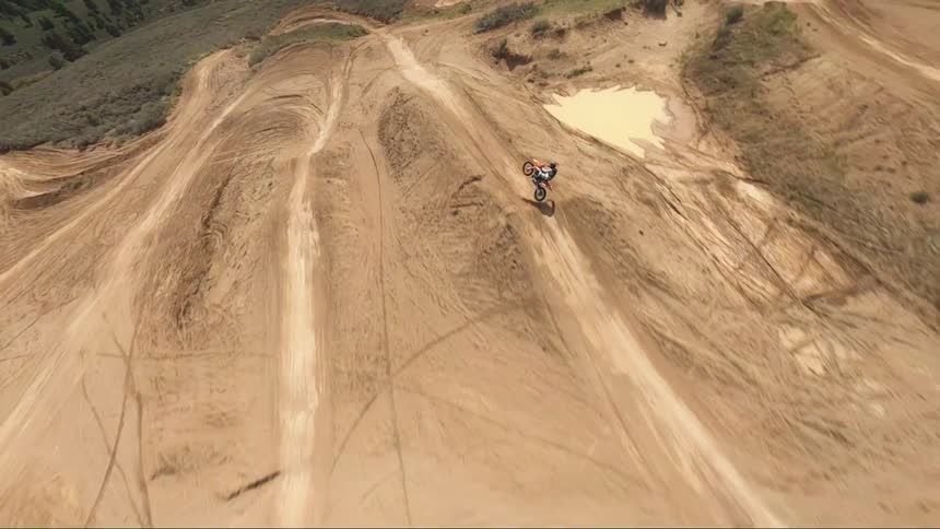 Aerial view of a motocross motorcycle driving on a motocross course