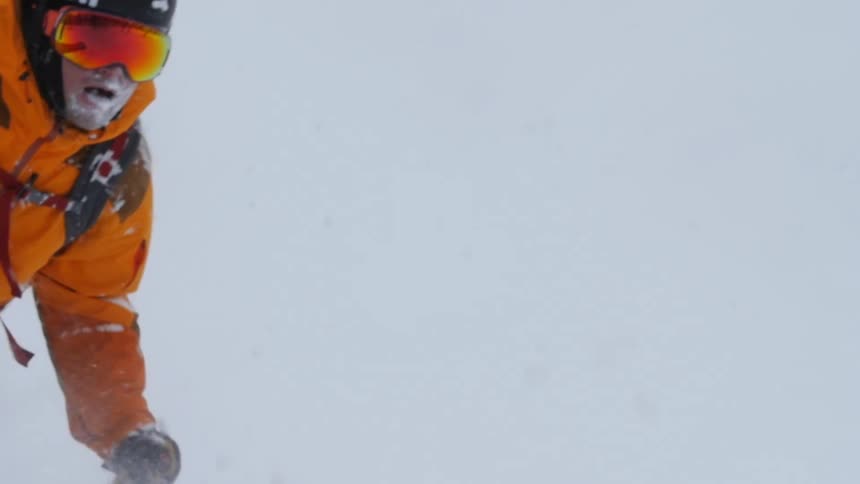 A man skiing down a snowy hill
