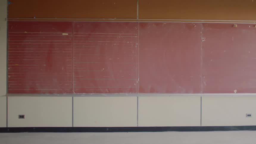 Red chalkboard on wall in older school building