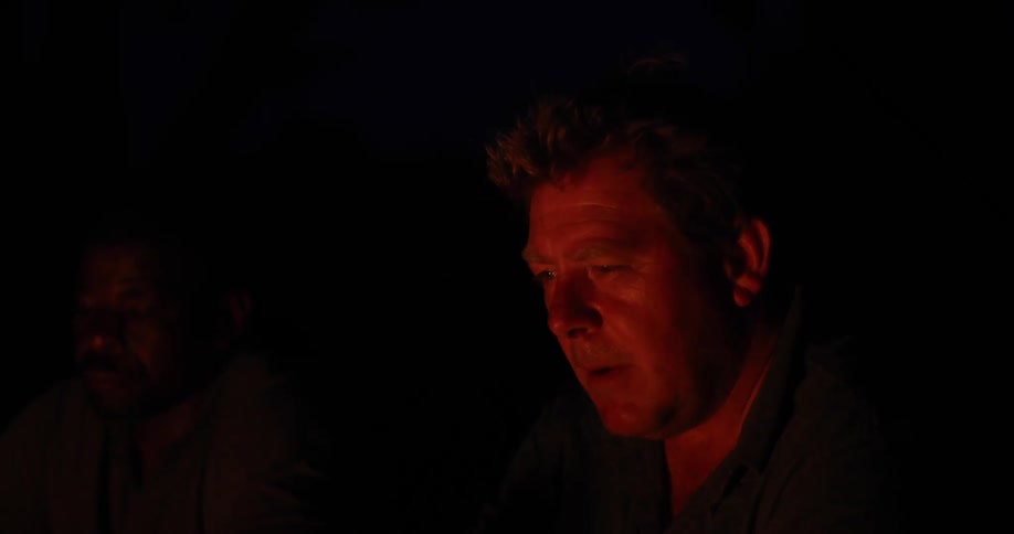 A man smokes a cigarette at night