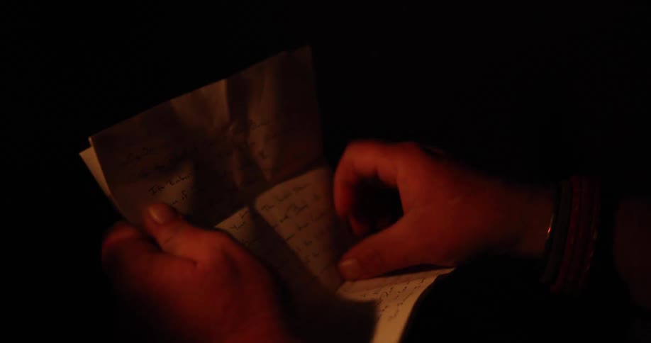A man opens up a letter
