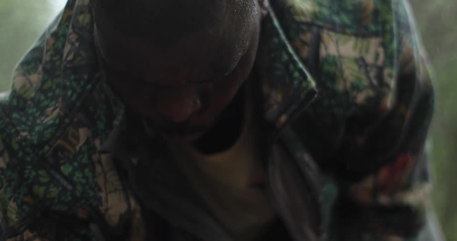 A man chopping outside chopping with a large knife