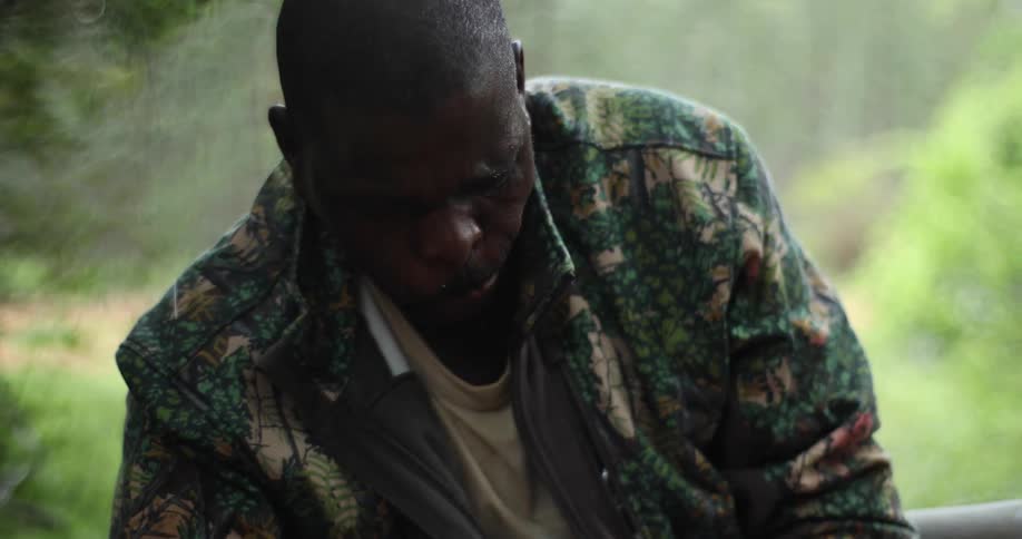 A man is using a machete to chop something