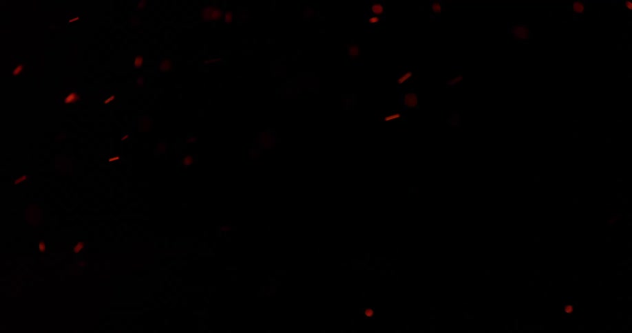 Red sparks coming out of a fire in the night