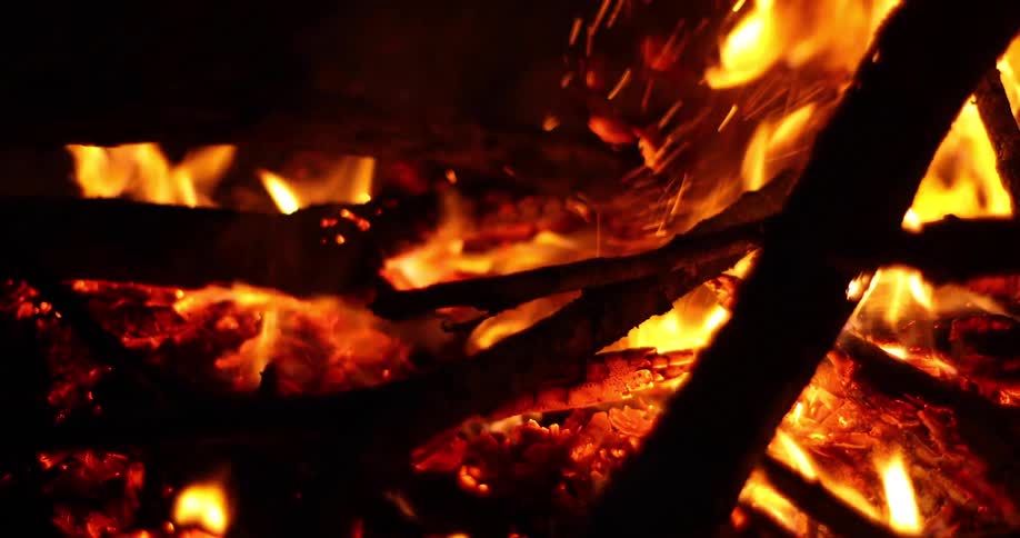 Branches burn while being poked with another branch
