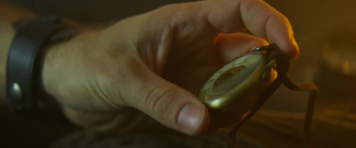 A man picks up a timepiece