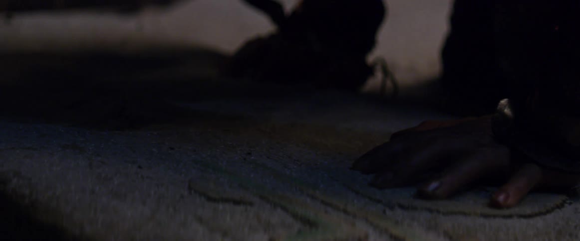 Hand rests with its palm down on the sand