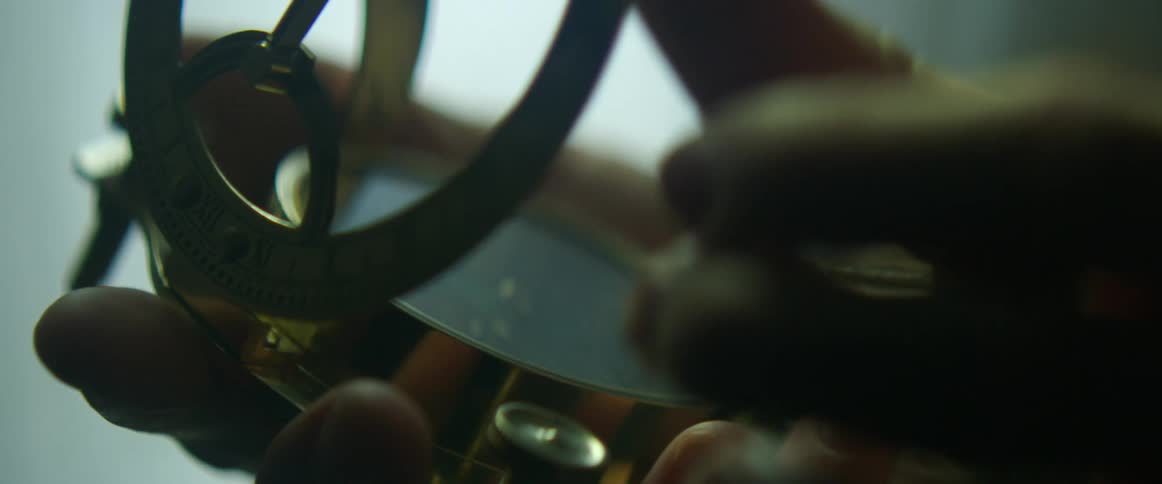 A person opens a lid on a compass