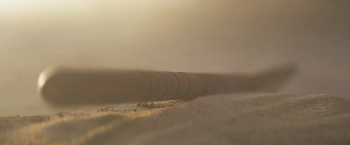 Sand blows around an object sitting out in the desert