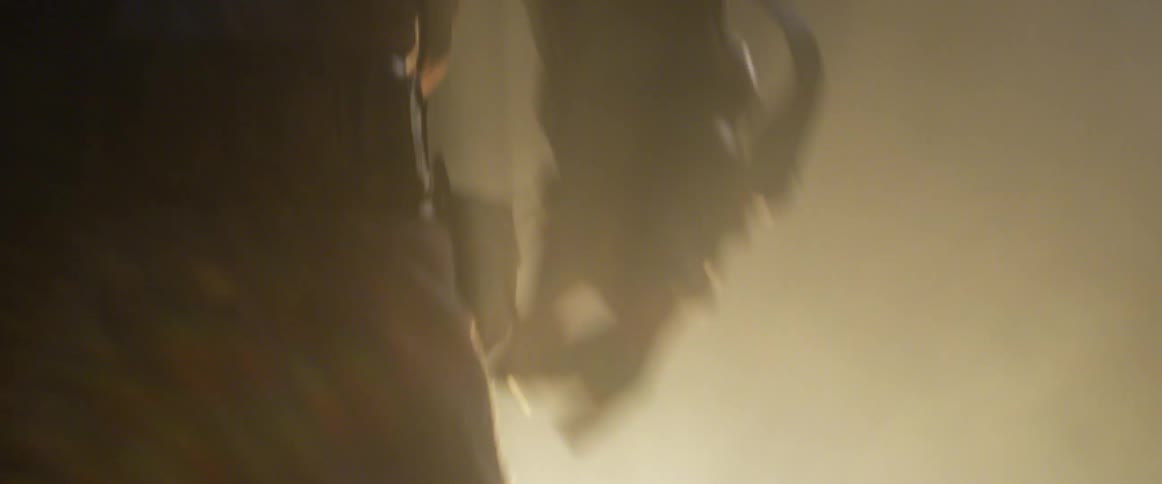 Silhouette of a man in robes walking through smoke