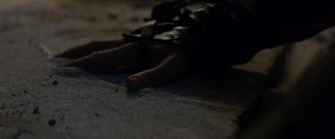 A person runs their hand through the sand